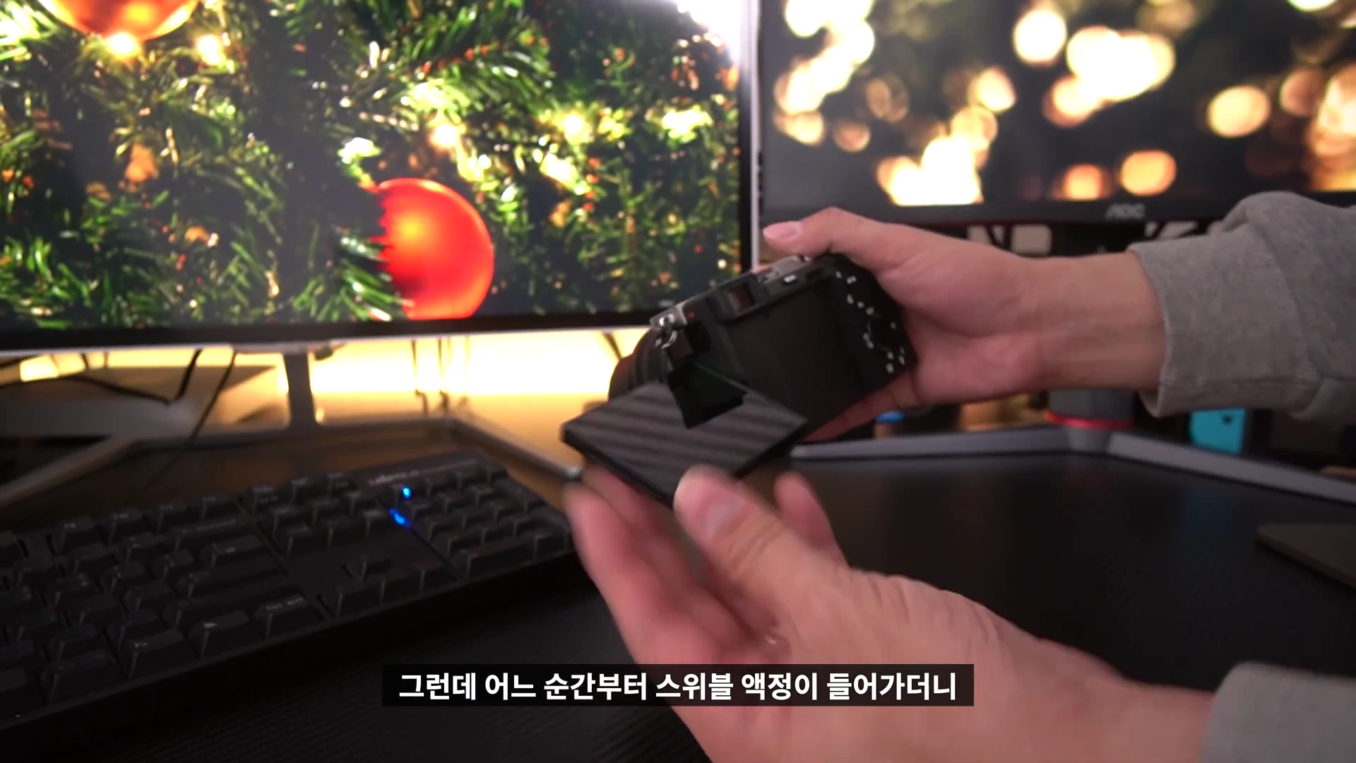 손으로 미러리스 카메라의 스위블 액정을 펼쳐 보이는 모습
