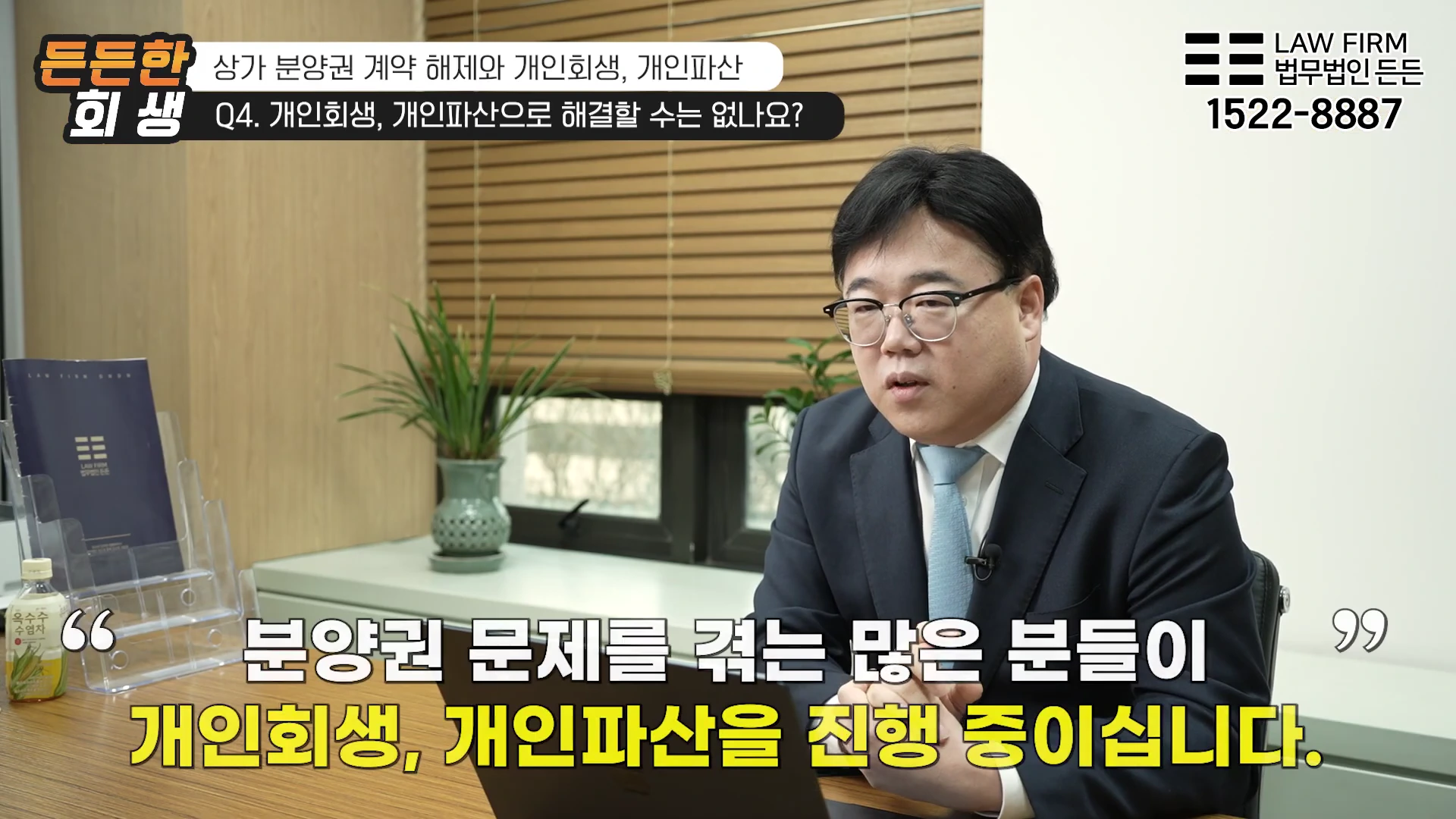 안경을 쓴 남성 변호사가 사무실 책상에 앉아 인터뷰하는 모습이 담긴 영상 화면