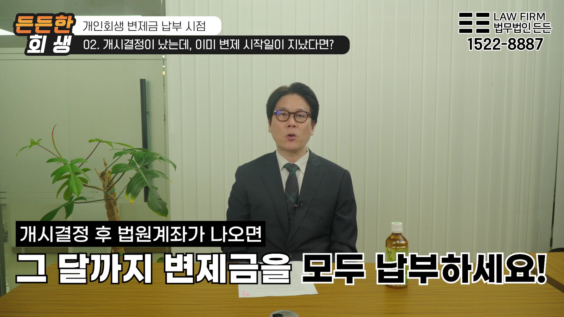 안경을 쓴 남성 변호사가 사무실 책상에 앉아 개인회생 변제금 납부 방법에 대해 설명하고 있는 영상 화면