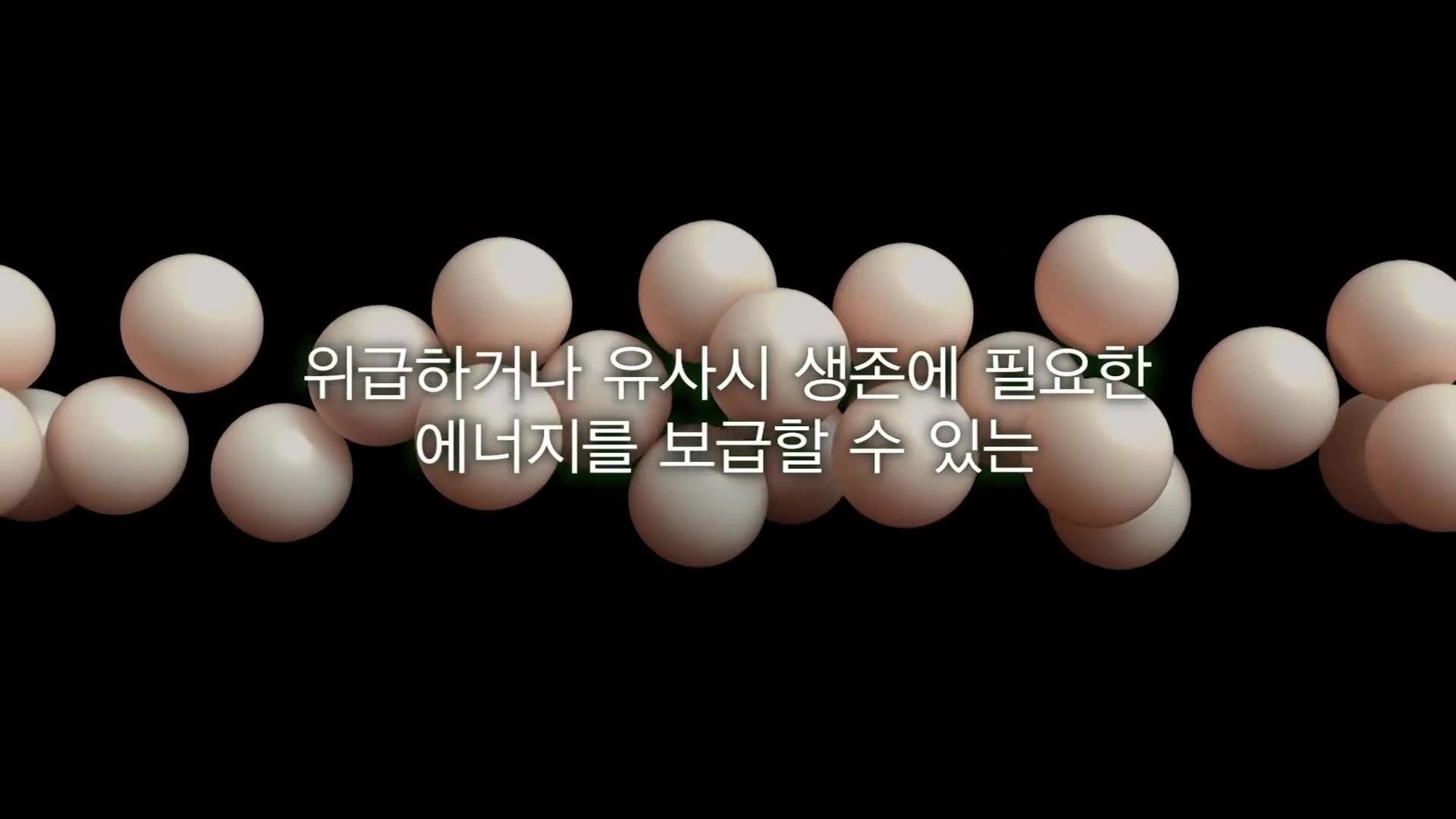 검은 배경 위에 떠 있는 다수의 옅은 분홍색 구체들과 그 중앙에 흰색 자막이 배치된 영상 화면.