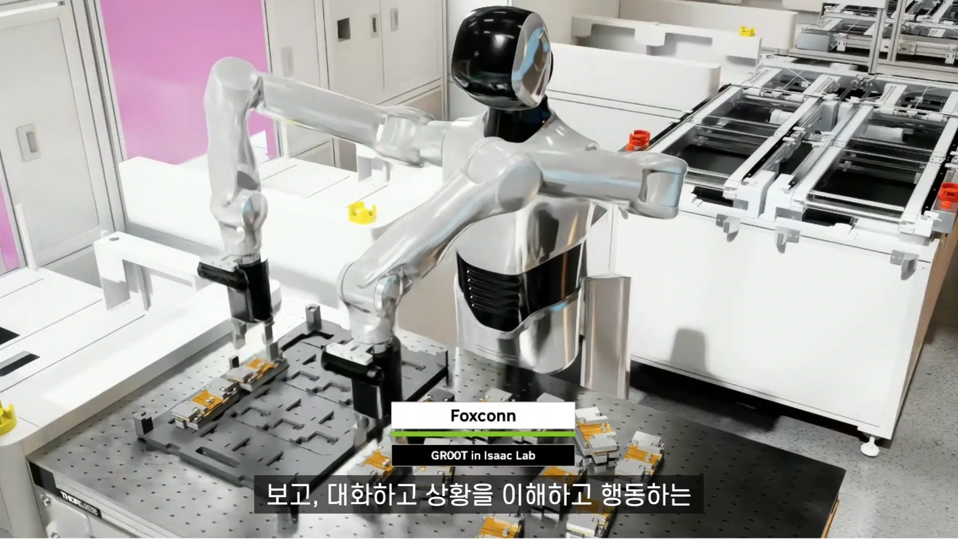 실버와 블랙 컬러의 휴머노이드 로봇이 작업대 위에서 부품을 다루고 있으며, 화면 중앙에는 Foxconn 및 GROOT in Isaac Lab이라는 문구가 자막으로 표시되어 있습니다.