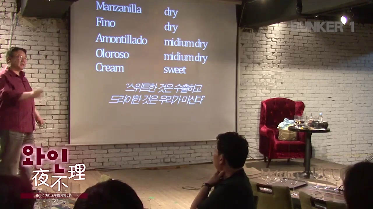 강연자가 스크린을 가리키며 셰리 와인의 당도 분류와 '스위트한 것은 수출하고 드라이한 것은 우리가 마신다'라는 문구가 적힌 발표 자료를 설명하고 있다.