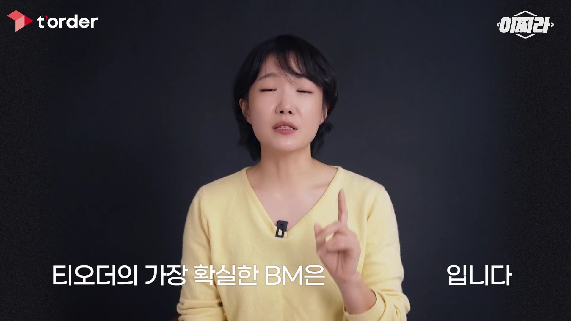 단발머리의 한 여성 출연자가 검은색 배경 앞에서 손가락으로 숫자 1을 가리키며 설명하고 있으며, 하단에는 '티오더의 가장 확실한 BM은'과 '입니다'라는 자막이 배치되어 있습니다.