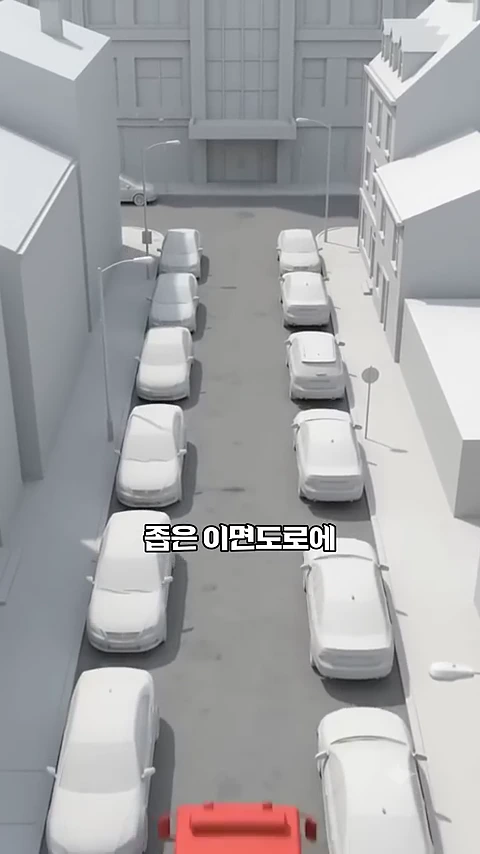 도로 양옆으로 주차된 흰색 차량들 사이로 빨간색 소방차가 진입하려는 모습을 위에서 내려다본 3D 그래픽 모델.