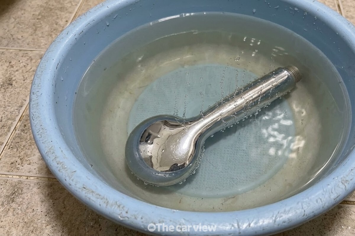 노즐 면이 아래로 가게 식초물에 완전히 잠긴 헤드 둘레로 잔거품이 올라오고 있다. / 기사 이해를 돕기 위한 생성형 이미지