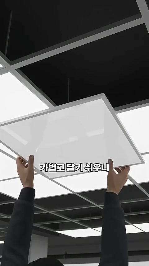 두 손으로 필로티 주차장 천장에 사각형의 흰색 마감재를 끼워 넣는 모습이 담긴 영상 캡처 화면입니다.