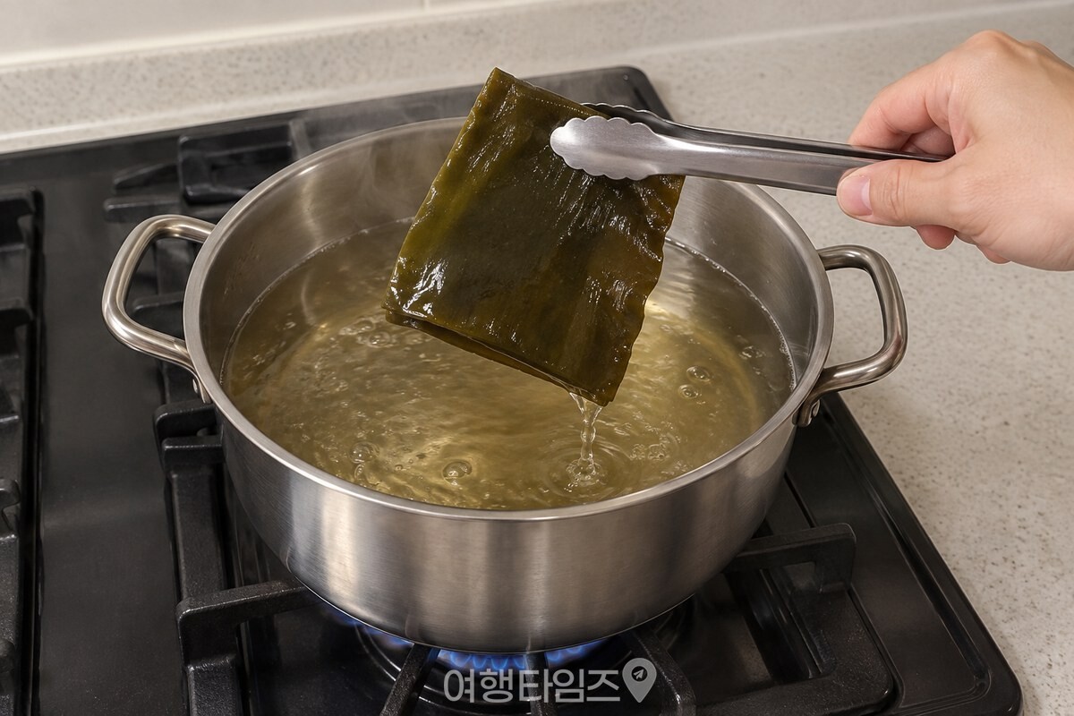 물이 끓기 시작한 냄비에서 집게로 다시마 한 장을 건져 올리는 모습. / 기사 이해를 돕기 위한 생성형 이미지