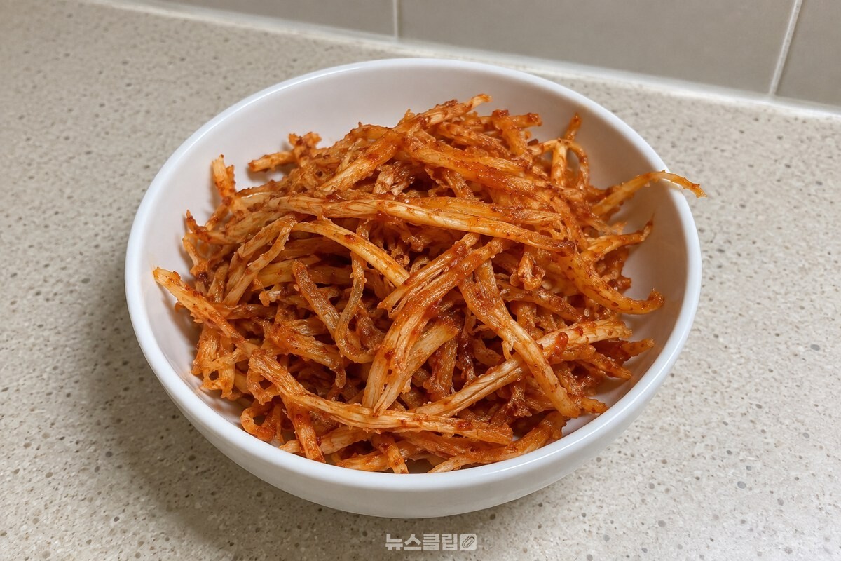 흰 반찬그릇에 담긴 진미채볶음으로, 붉은 양념이 묻은 가닥이 서로 떨어져 있다. / 기사 이해를 돕기 위한 생성형 이미지