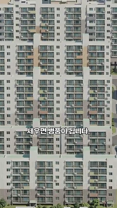 남향을 향해 나란히 배치된 고층 판상형 아파트 외관과 그 위에 적힌 '세우면 병풍이 됩니다.'라는 한글 자막이 보이는 화면