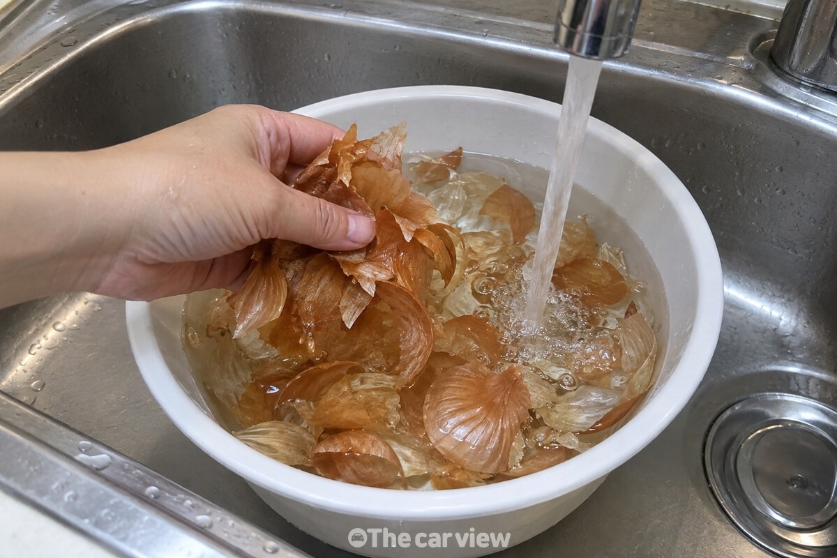 물에 담근 양파 겉껍질을 깨끗한 손으로 부드럽게 헹구는 모습. / 기사 이해를 돕기 위한 생성형 이미지
