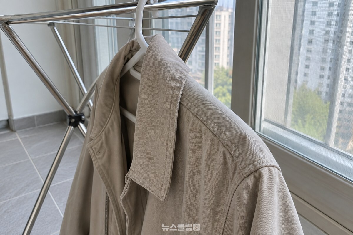 베란다 빨래건조대에 걸린 겉옷의 옷깃과 섬유 결을 가까이에서 담은 모습 / 기사 이해를 돕기 위한 생성형 이미지