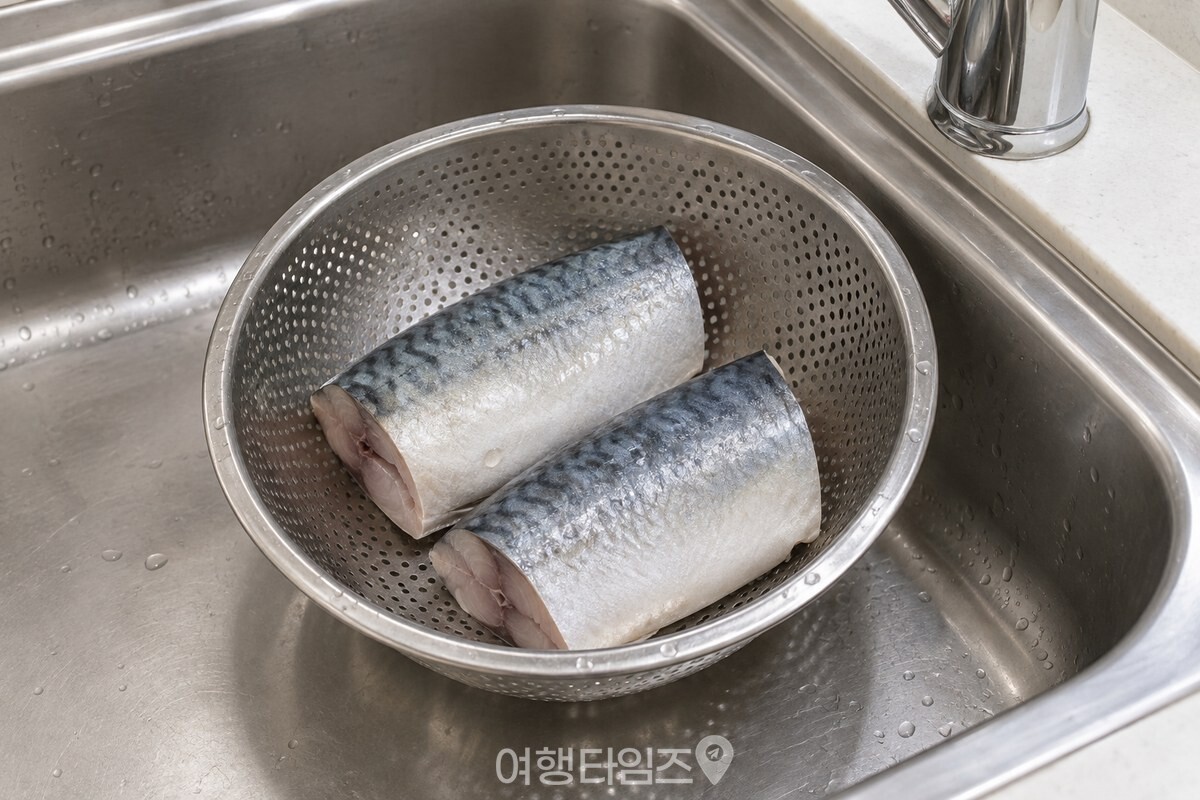 흐르는 물에 헹군 손질 고등어를 스테인리스 채반에 올려 물기를 뺀 모습입니다. / 기사 이해를 돕기 위한 생성형 이미지