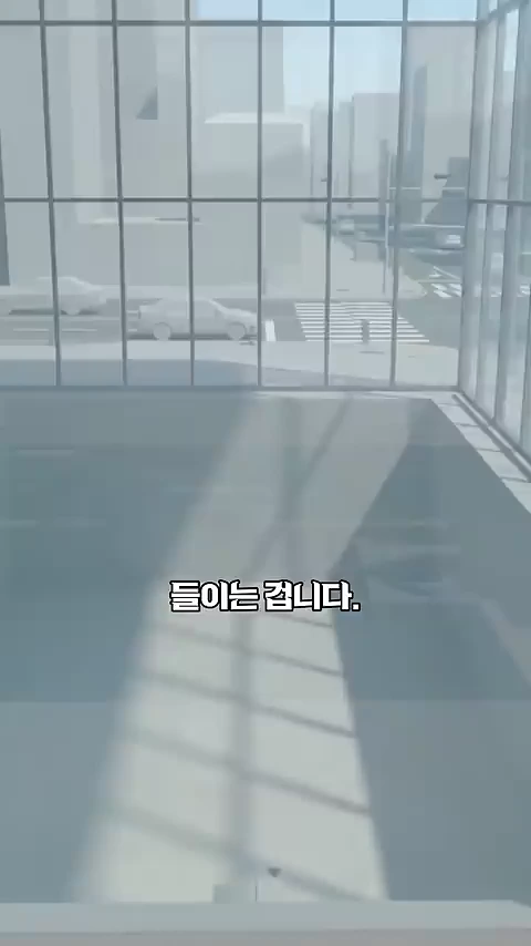 통유리창 너머로 현대적인 도심 거리와 자동차들이 보이는 건물 내부의 모습을 3D 그래픽으로 표현한 영상 장면.