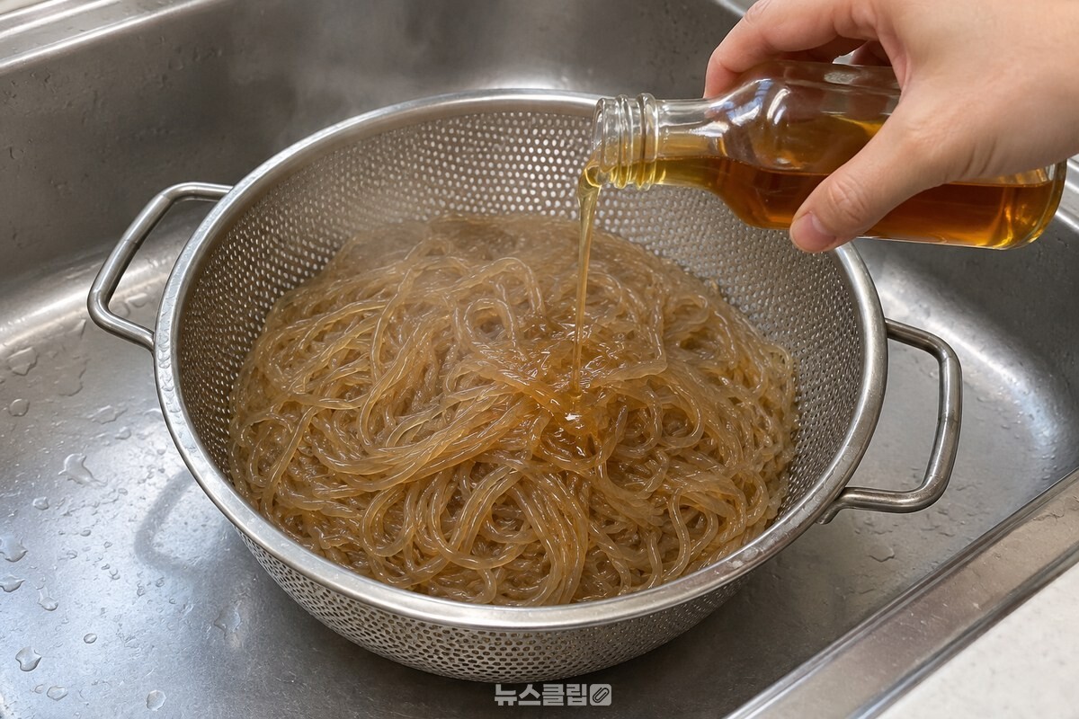 체에 밭친 뜨거운 당면 위로 참기름을 얇게 두르는 장면. / 기사 이해를 돕기 위한 생성형 이미지