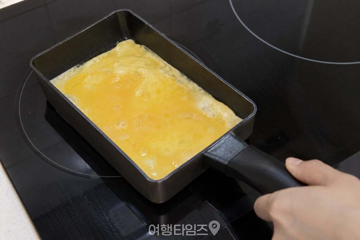 깨끗한 사각 팬 가장자리에서 천천히 익기 시작한 얇은 계란물. / 기사 이해를 돕기 위한 생성형 이미지
