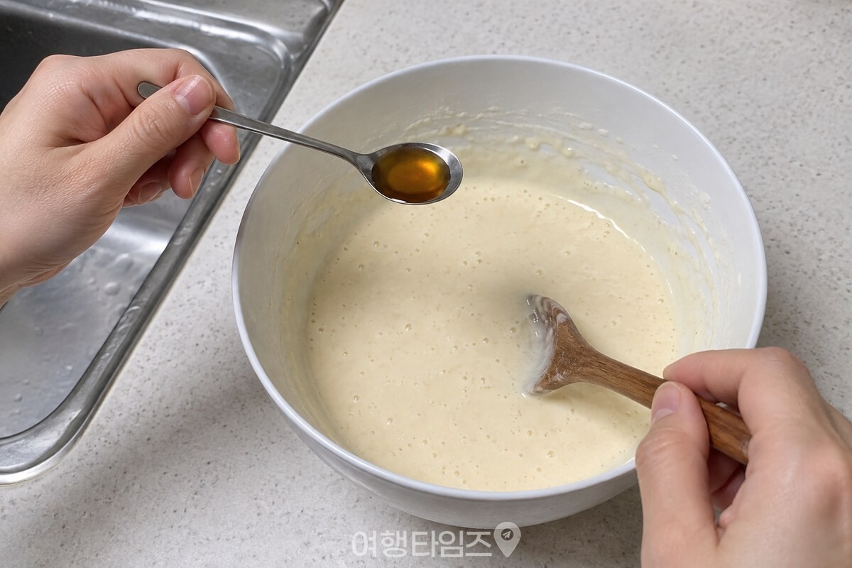 커피스푼으로 잰 참치액을 묽은 반죽에 넣고 섞는 모습이다. / 기사 이해를 돕기 위한 생성형 이미지