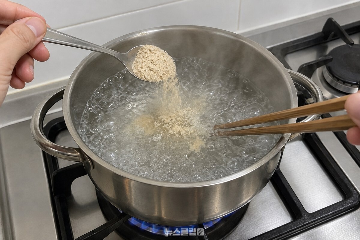 끓는 물이 담긴 냄비에 멸치가루를 작은술로 넣어 젓가락으로 푸는 모습. / 기사 이해를 돕기 위한 생성형 이미지