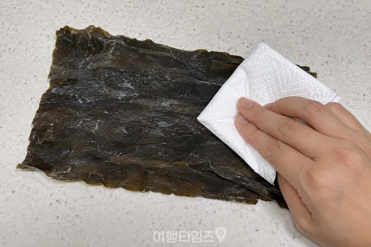 깨끗한 키친타월로 마른 다시마 표면을 가볍게 닦고 있다. / 기사 이해를 돕기 위한 생성형 이미지