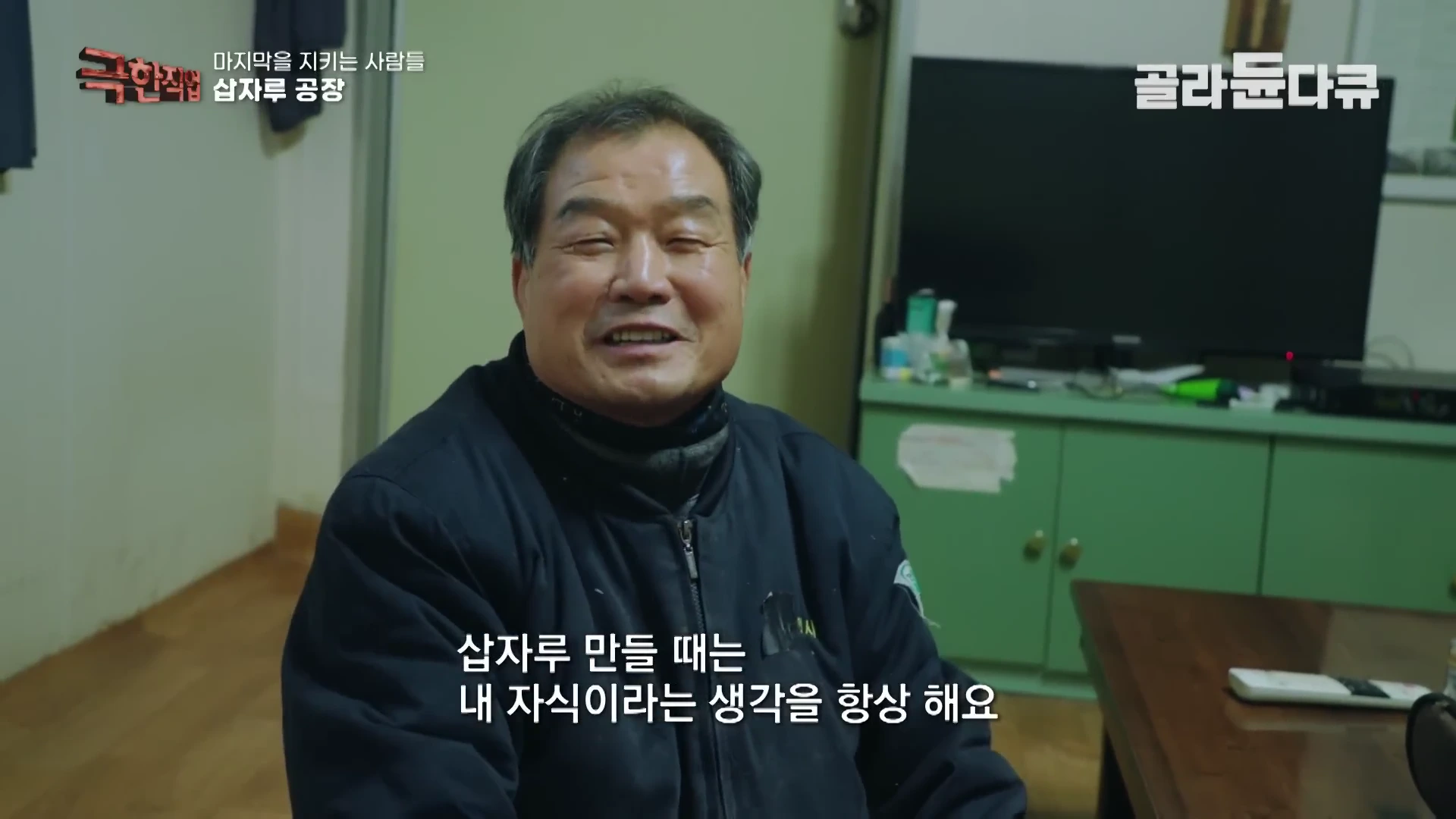 실내에서 검은색 작업복을 입은 중년 남성이 환하게 웃으며 앉아 있고, 화면 하단에는 '삽자루 만들 때는 내 자식이라는 생각을 항상 해요'라는 자막이 표시되어 있습니다.