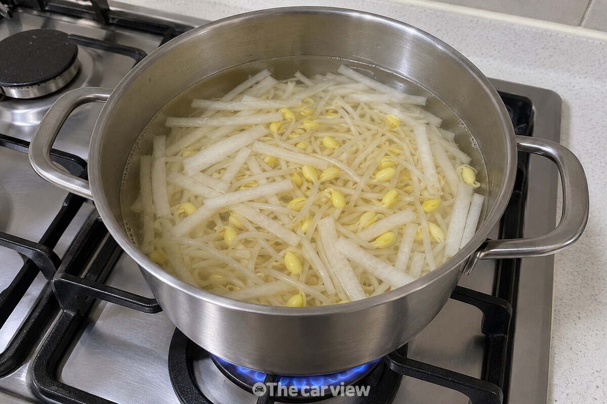 차가운 멸치육수에 무채와 콩나물을 넣은 냄비를 센불에 올린 모습이다. / 기사 이해를 돕기 위한 생성형 이미지
