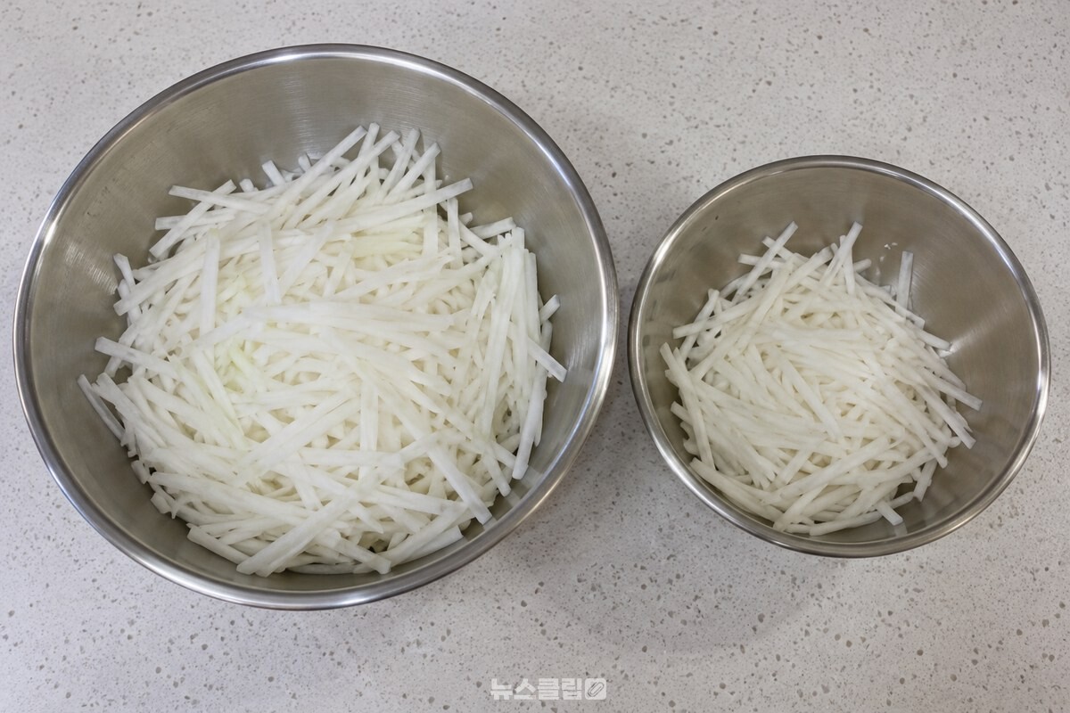 가늘게 썬 무채를 큰 그릇과 작은 그릇에 나눠 담아 아래층과 윗층 분량을 준비한 모습입니다. / 기사 이해를 돕기 위한 생성형 이미지