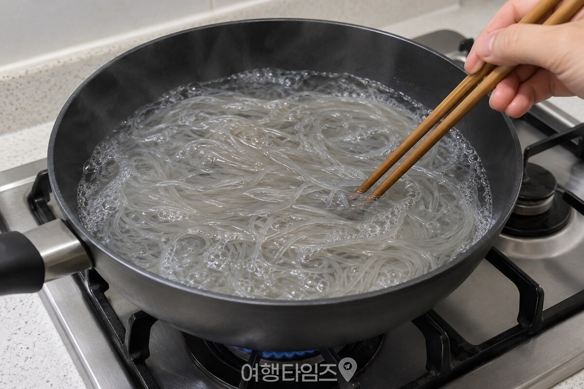 끓는 물에 넣은 당면을 젓가락으로 살살 눌러 펼치는 모습. / 기사 이해를 돕기 위한 생성형 이미지