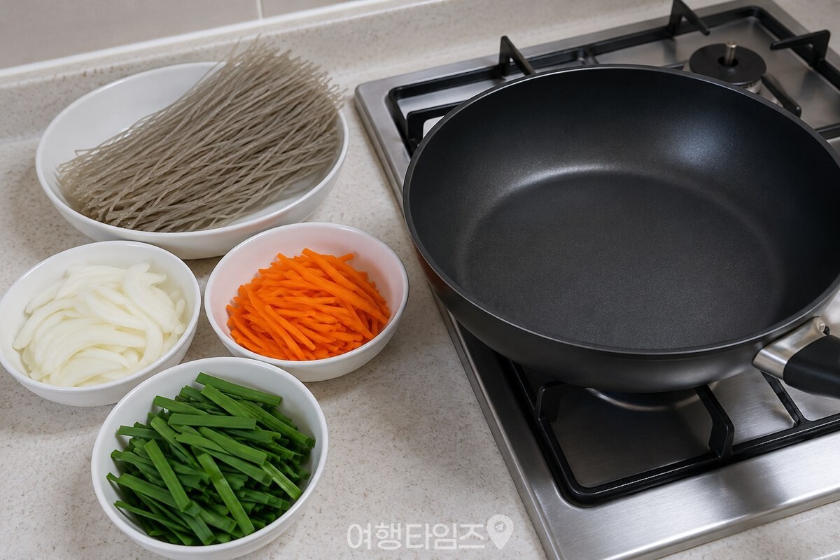 마른 당면과 가늘게 썬 채소를 넓은 팬 옆에 준비한 모습. / 기사 이해를 돕기 위한 생성형 이미지
