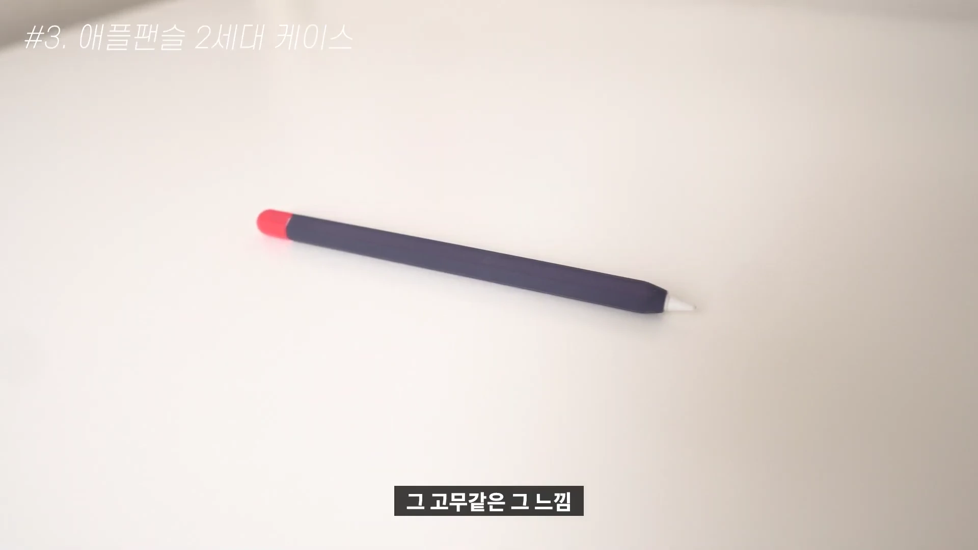 흰색 배경 위에 실리콘 케이스를 씌운 애플펜슬이 놓여 있고 화면 상단에는 '#3. 애플펜슬 2세대 케이스'라는 문구가, 하단에는 '그 고무같은 그 느낌'이라는 자막이 표시되어 있습니다.
