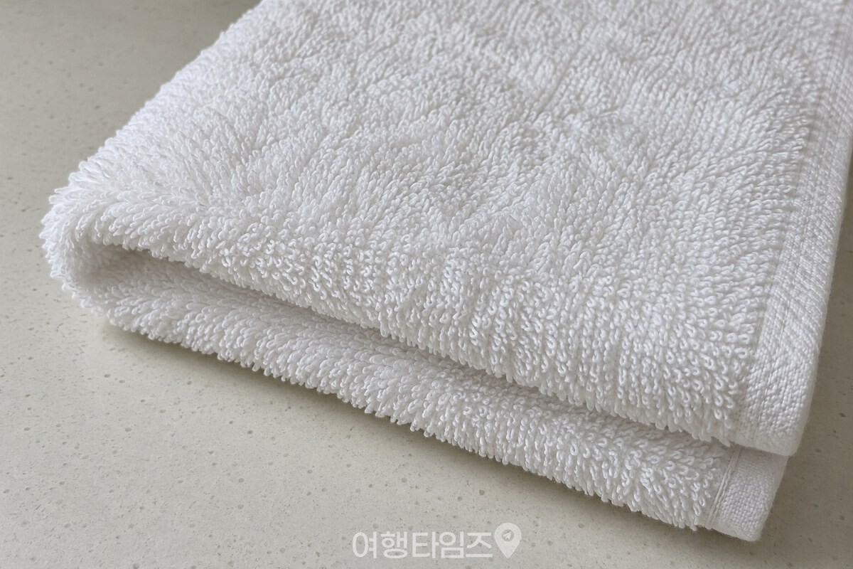 흰 면 수건의 촘촘한 고리 올이 가까이 보이도록 접힌 단면을 촬영한 모습 / 기사 이해를 돕기 위한 생성형 이미지