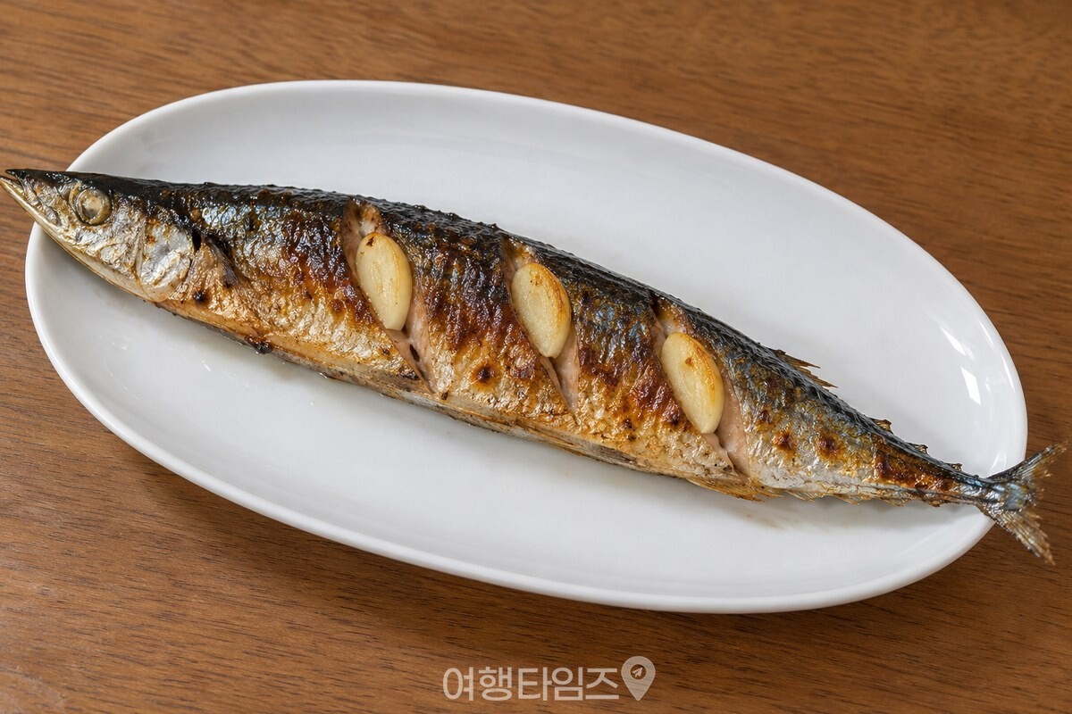 편마늘을 꽂아 노릇하게 구운 꽁치 한 접시 / 기사 이해를 돕기 위한 생성형 이미지