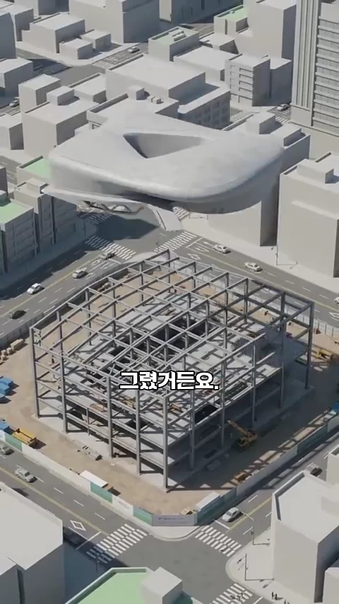 3D 그래픽으로 구현된 도심의 건설 현장과 그 위를 떠 있는 건축물 조각.