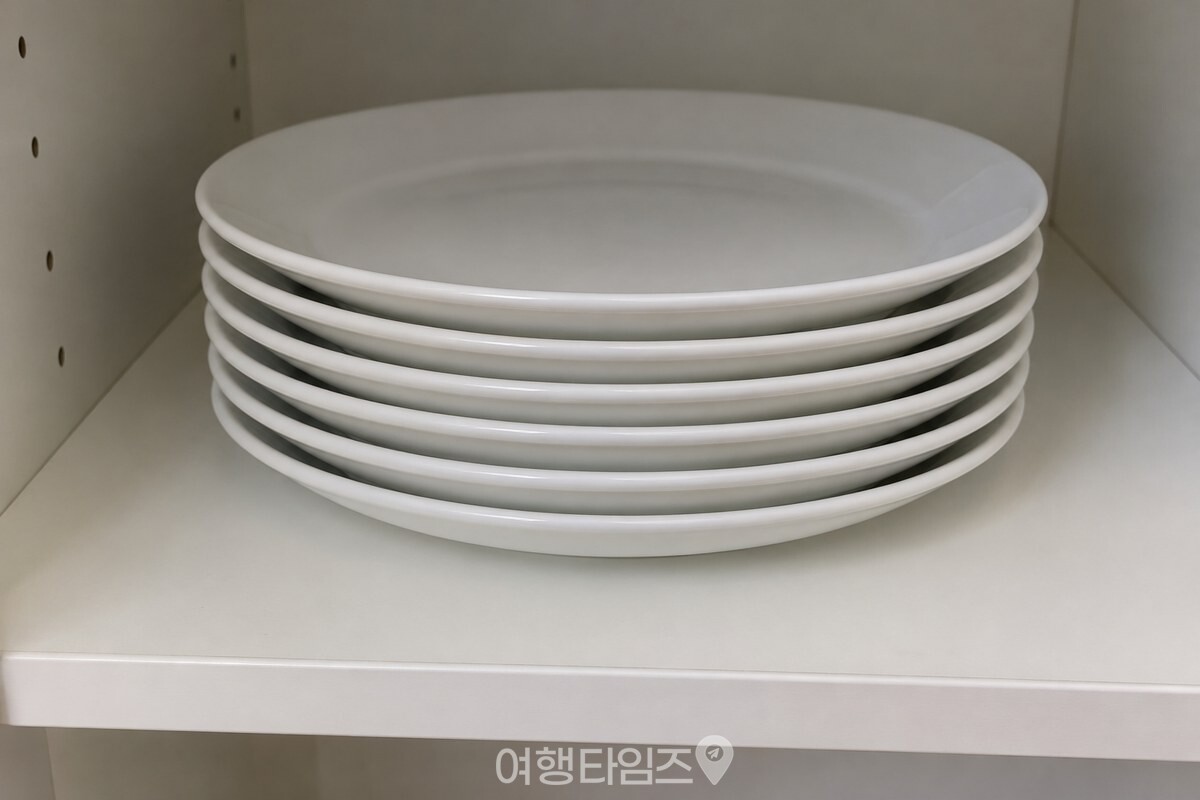 그릇장 선반에 포개어 쌓인 같은 크기 접시 / 기사 이해를 돕기 위한 생성형 이미지