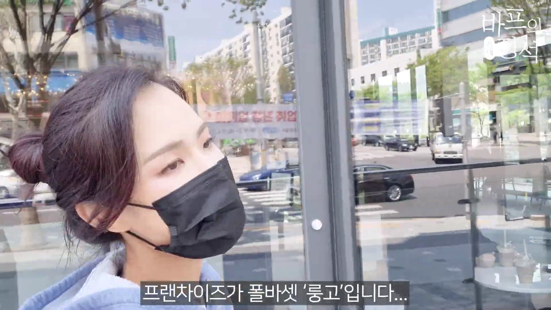 마스크를 쓴 여성이 유리창 너머로 거리 풍경이 보이는 카페 실내에서 이야기를 나누고 있는 모습