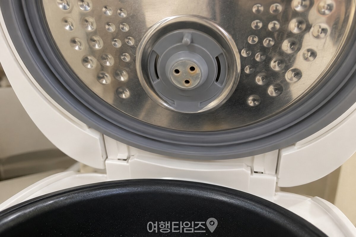 고무 패킹과 증기 배출구가 보이는 밥솥 뚜껑 안쪽 / 기사 이해를 돕기 위한 생성형 이미지
